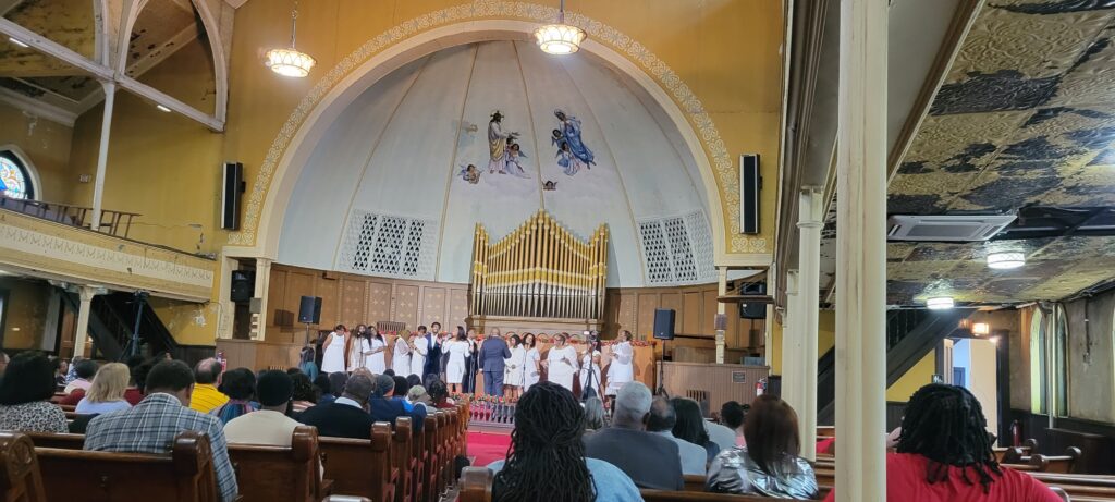 Quinn Chapel AME church celebrating their 128th June Rose Concert. On the left side of the picture is a new VRF cassette providing air conditioning during the concert.